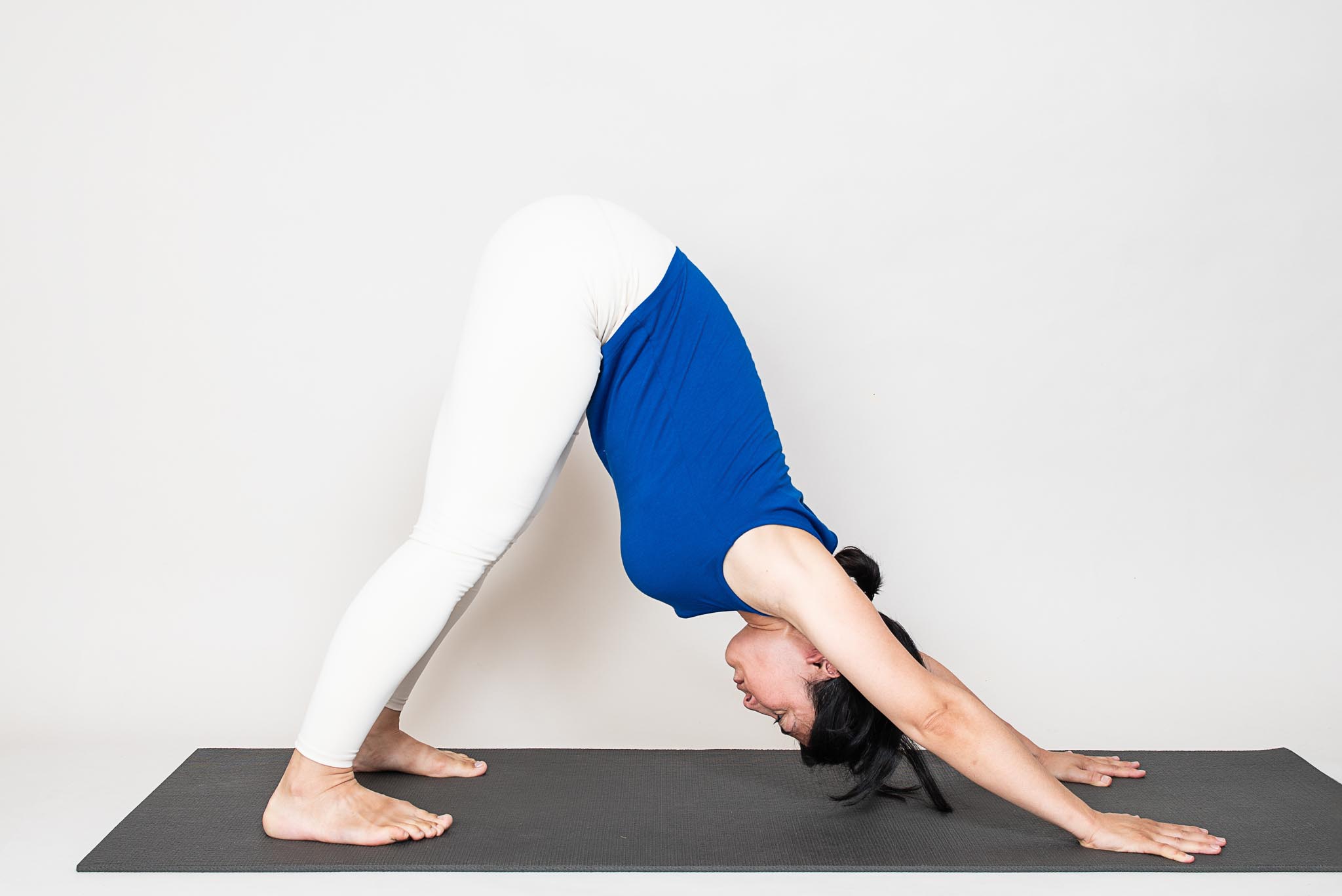 Woman practicing Adho Mukha Svanasana (Down Dog) yoga pose