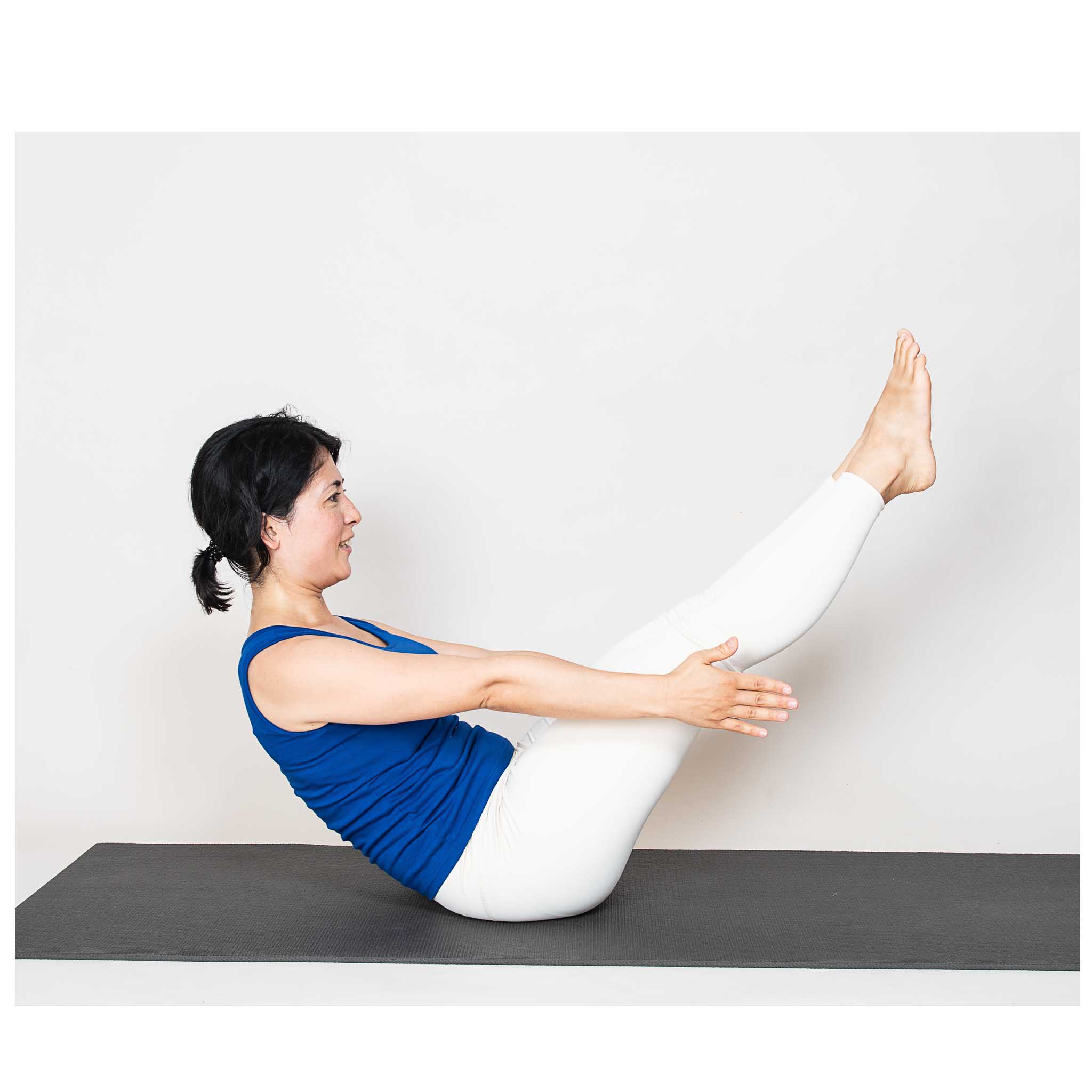 woman practicing boat pose 1 (navasana 1)